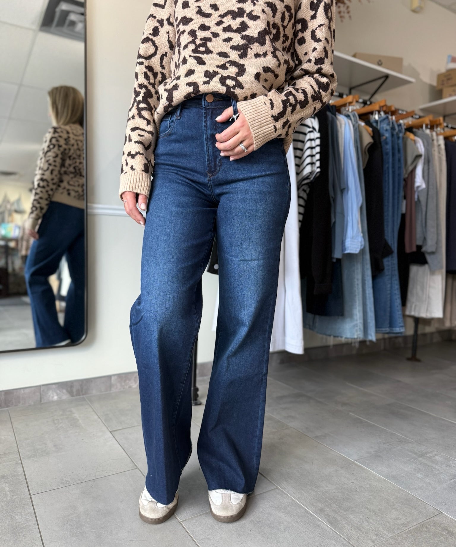 Woman wearing dark wash wide leg denim paired with leopard print sweater.