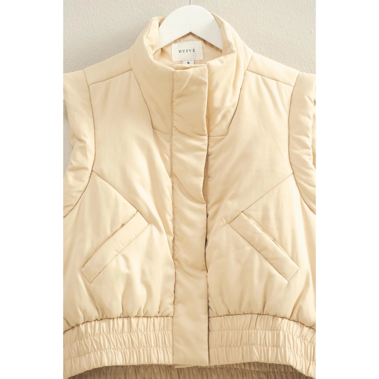 Beige vest with unique quilted details. 