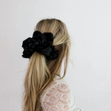woman wearing kaxi jumbo sleep scrunchie in black.
