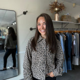Woman wearing a leopard print jacket paired with dark denim.