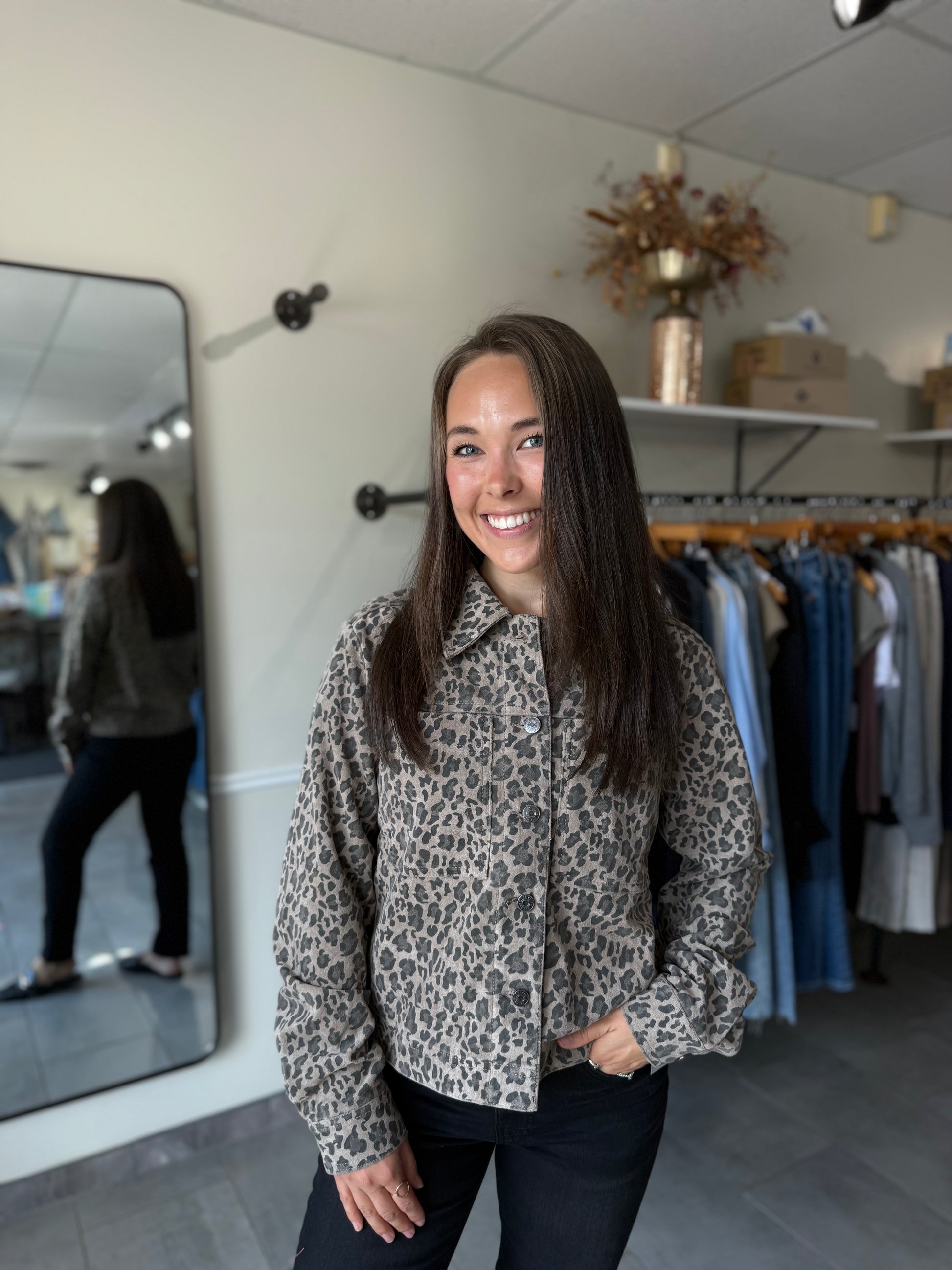Woman wearing a leopard print jacket paired with dark denim.