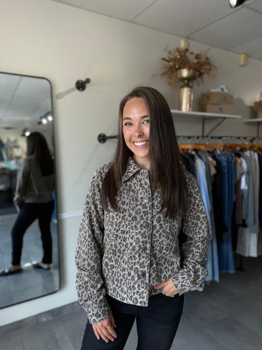 Woman wearing a leopard print jacket paired with dark denim.