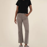 Woman wearing ankle length flare corduroy pants from the brand KUT in the color rosemary.