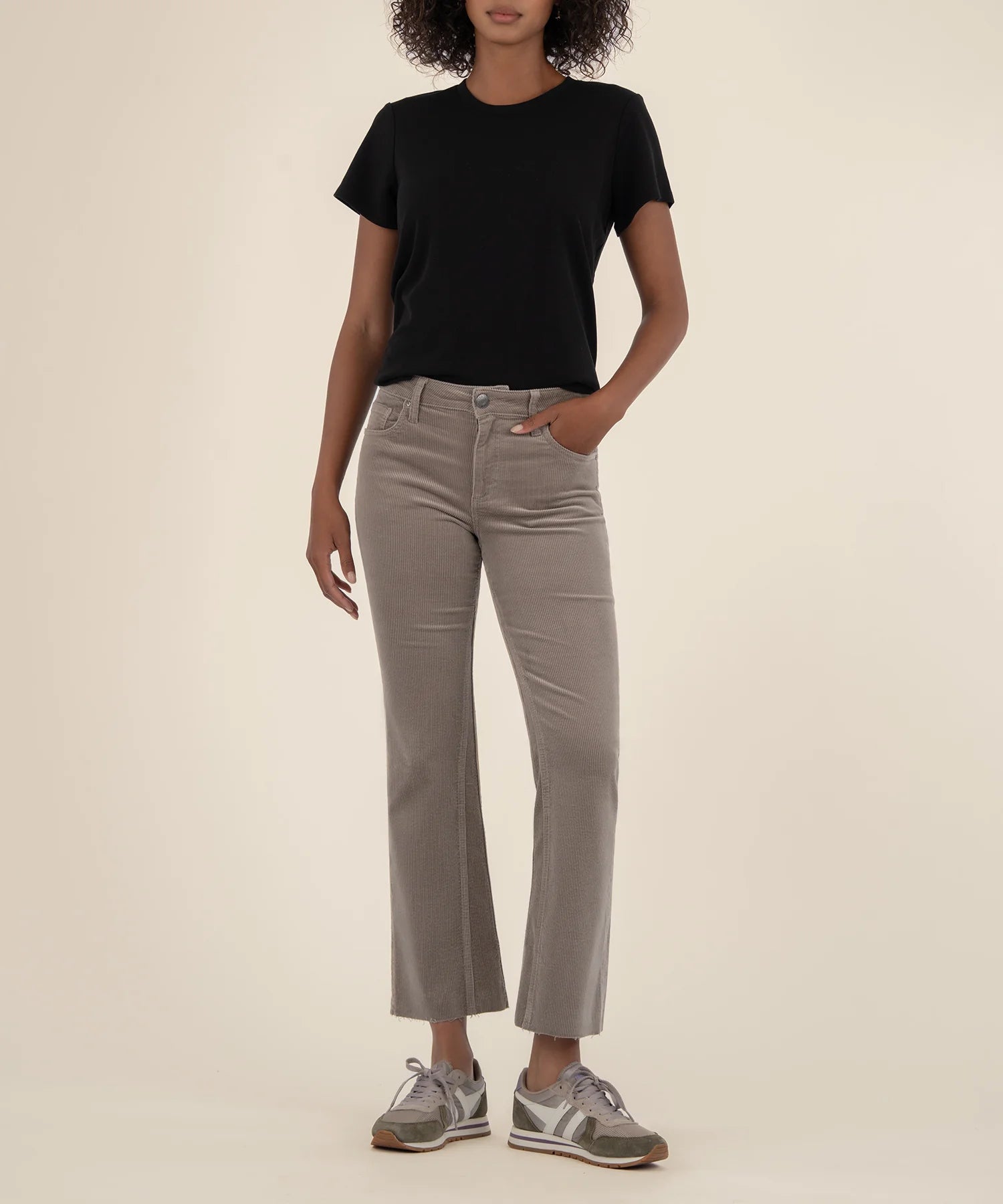 Woman wearing ankle length flare corduroy pants from the brand KUT in the color rosemary.