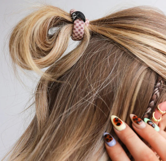 Hair tie with mauve and cream checkered print design and KAXI logo