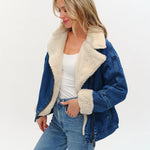 Model wearing an oversized denim jacket with sherpa lining from Six Fifty.