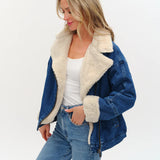Model wearing an oversized denim jacket with sherpa lining from Six Fifty.